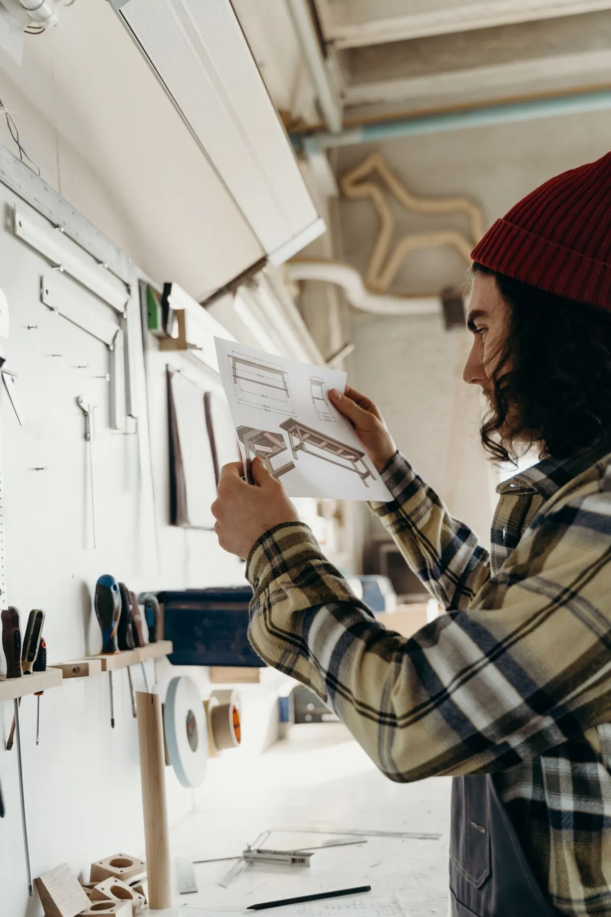 Artisan qui vérifie un plan dans son atelier