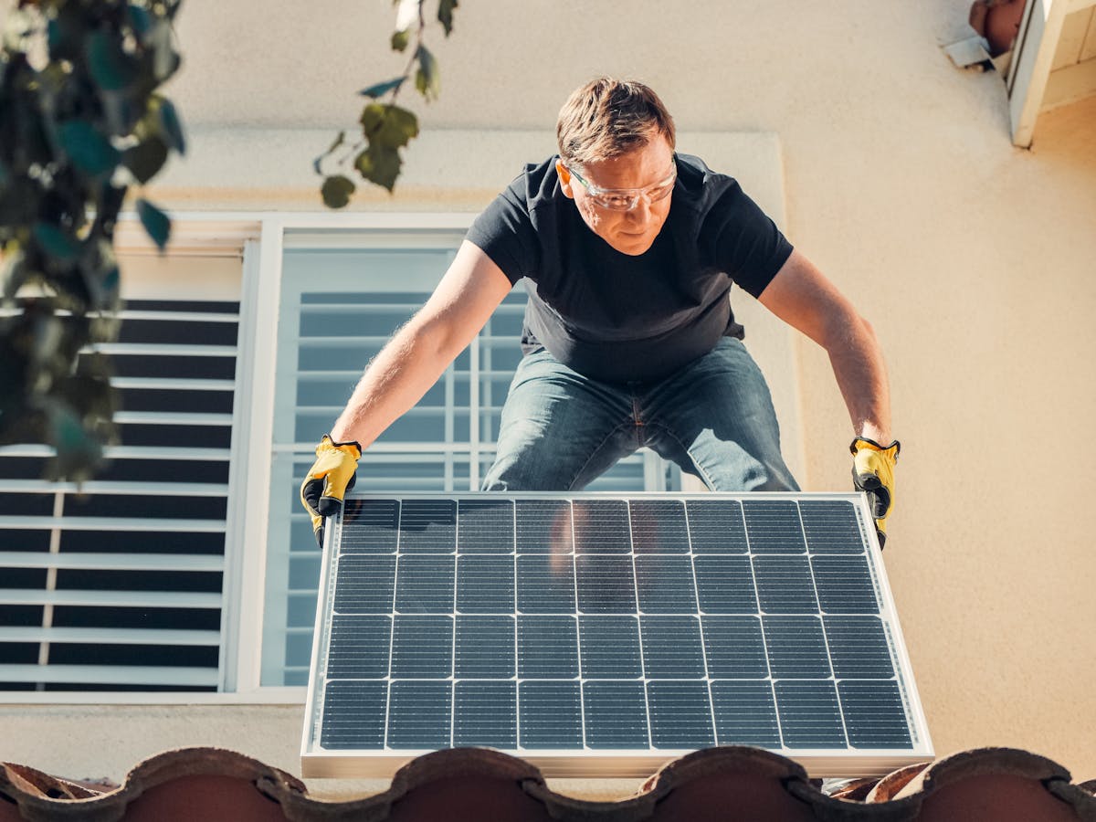 Installateur photovoltaïque posant un panneau solaire sur une toiture résidentielle — logiciel BatUp pour installateurs PV